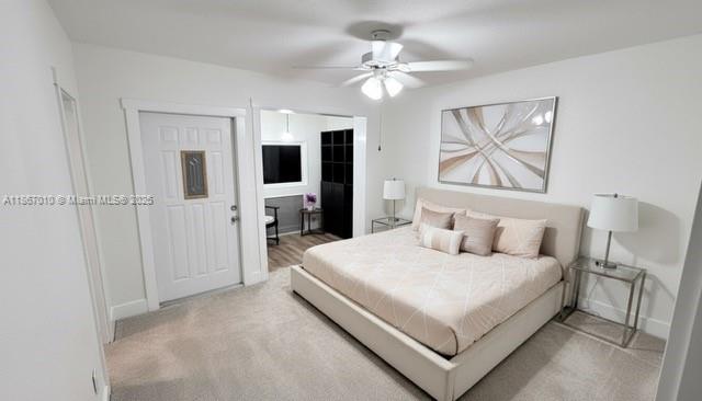 3911 Southwest 61st Avenue Miami, FL 33155 - Photo 30 of 38 a bedroom with a large bed a flat tv screen and chandelier