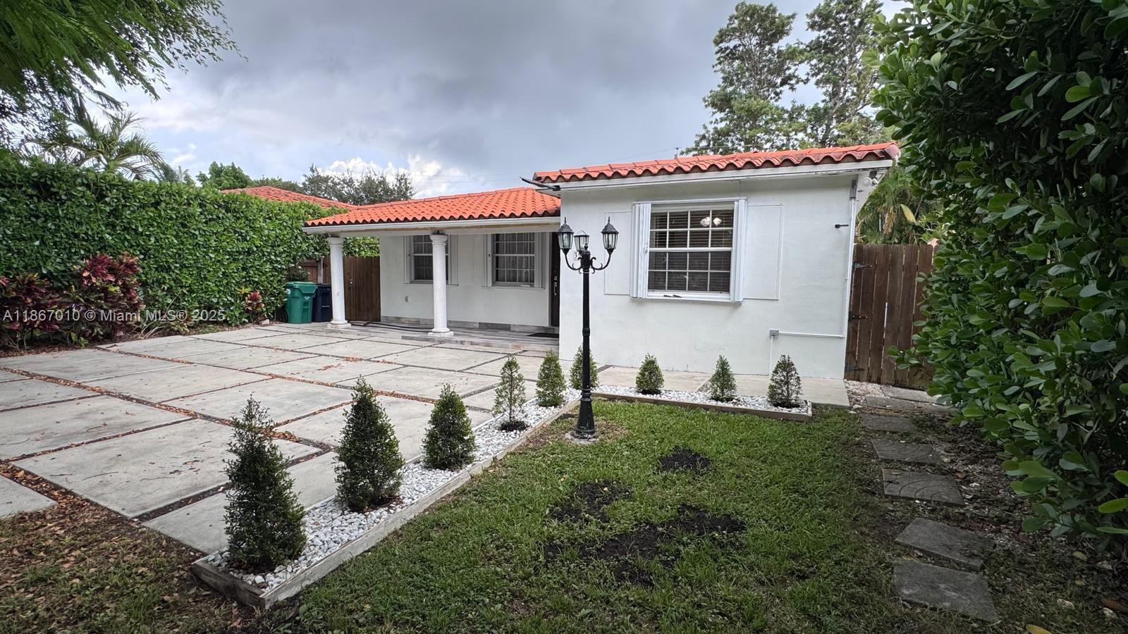 3911 Southwest 61st Avenue Miami, FL 33155 - Photo 5 of 38 a front view of a house with yard