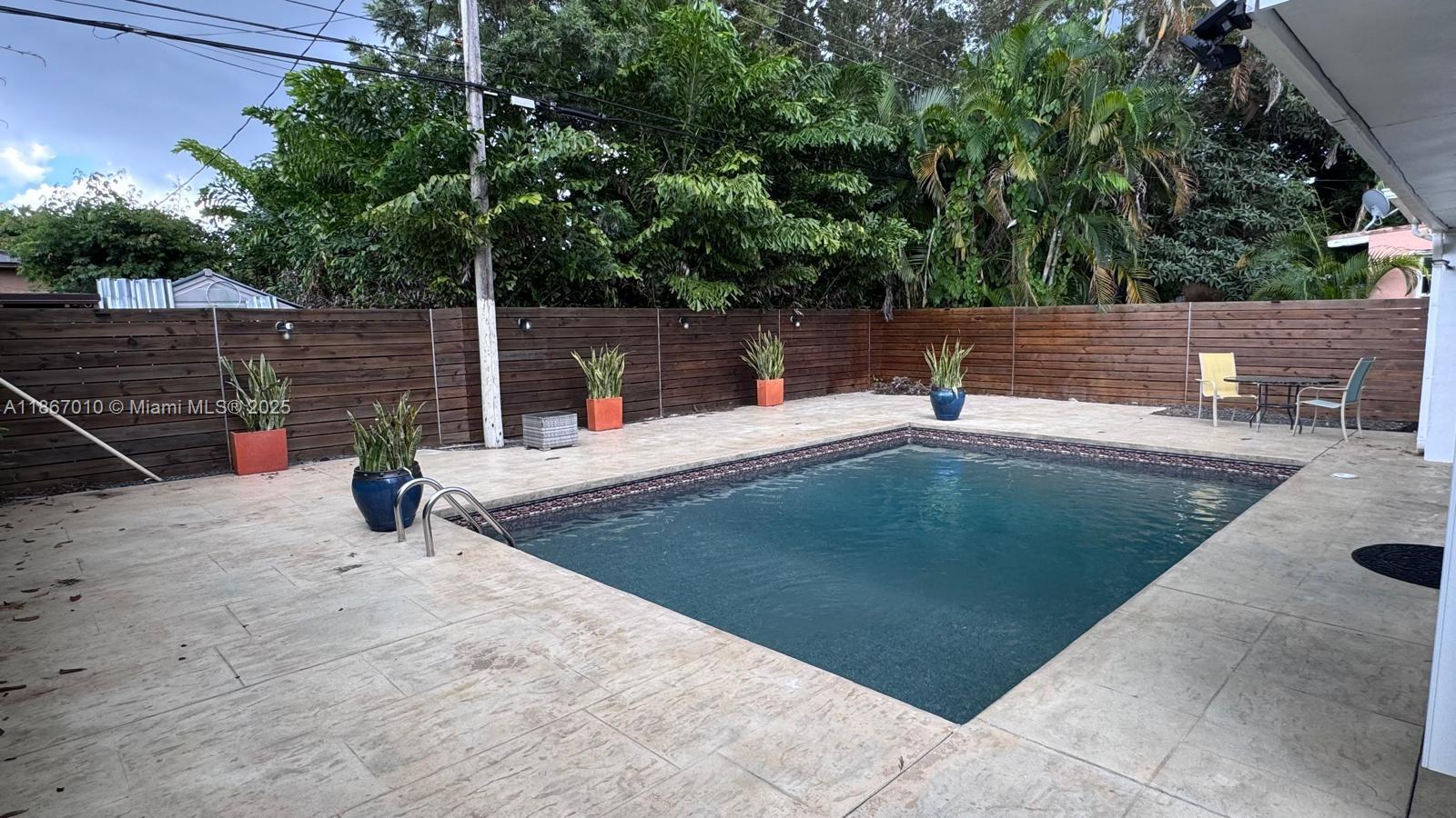 3911 Southwest 61st Avenue Miami, FL 33155 - Photo 7 of 38 a view of a swimming pool with a patio