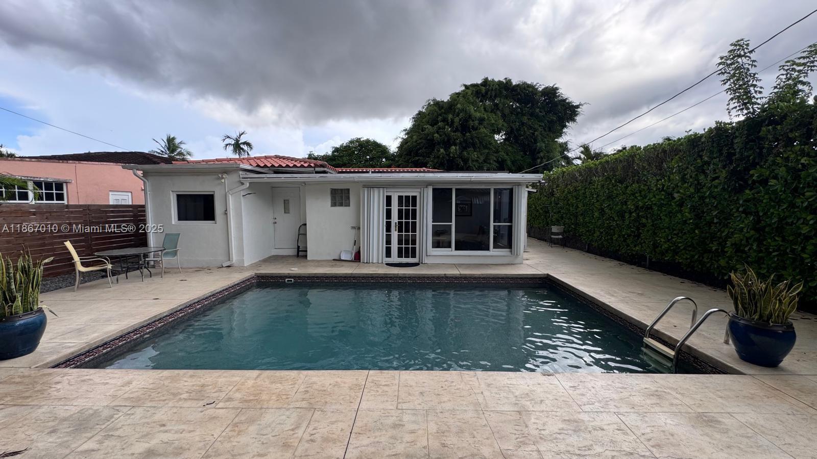 3911 Southwest 61st Avenue Miami, FL 33155 - Photo 9 of 38 a view of a house with swimming pool in front of it