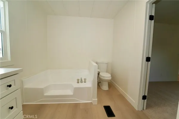 a bathroom with a bathtub and toilet