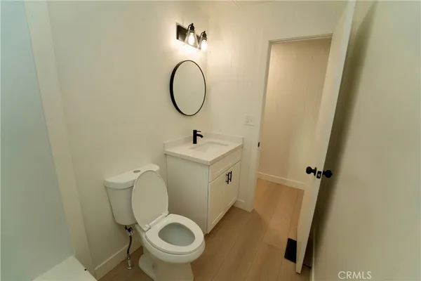 a bathroom with a toilet sink and a mirror
