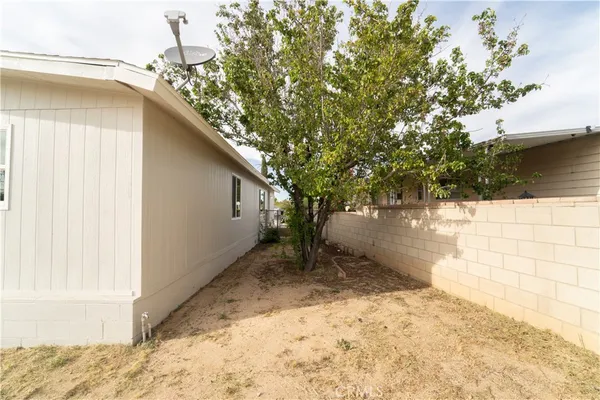 a backyard of a house with large trees