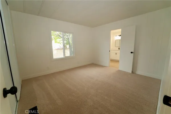 a view of an empty room and a window