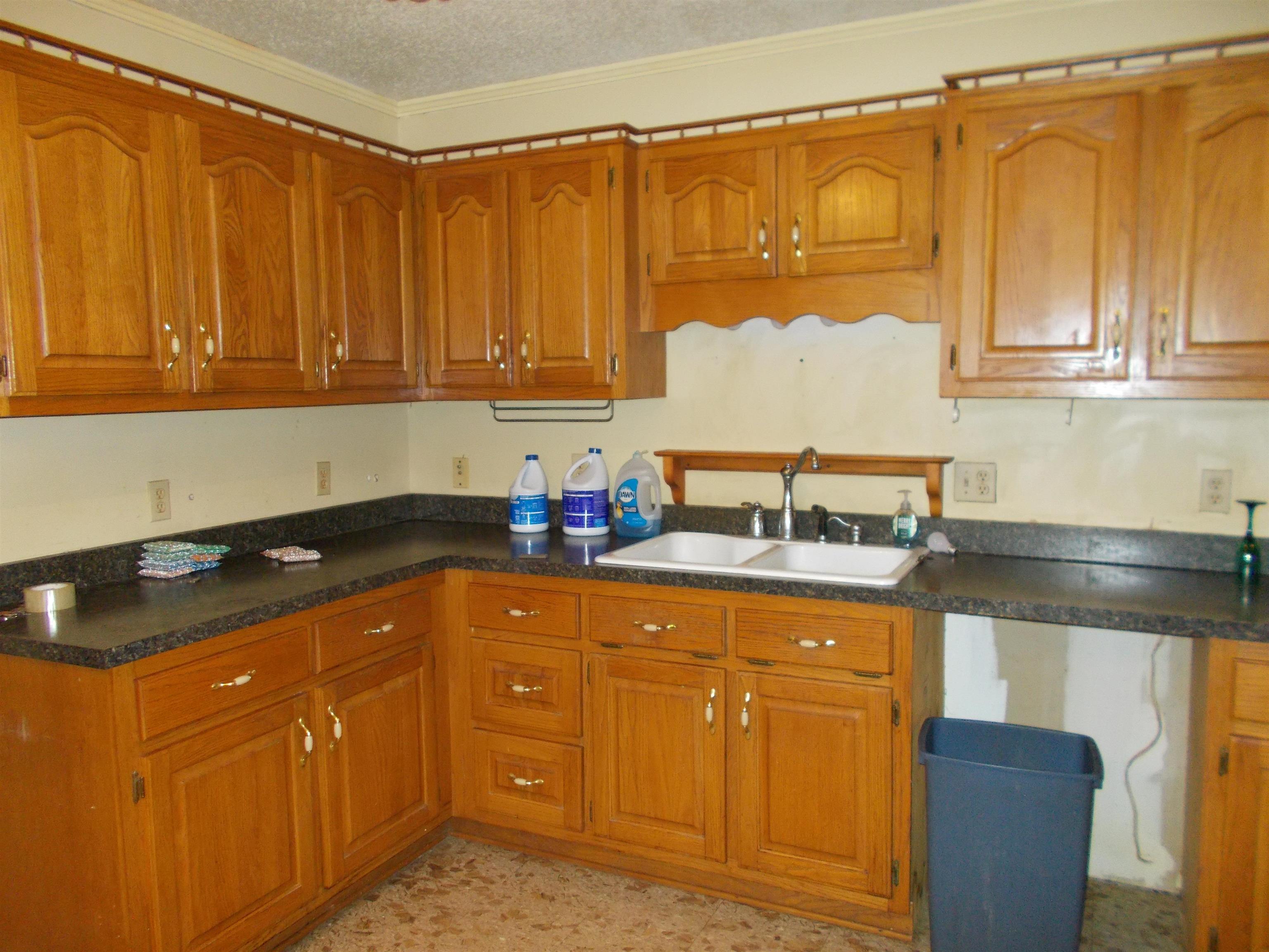 1058 Thumb Road Henning, TN 38041 - Photo 9 of 25 a kitchen with granite countertop a sink and cabinets