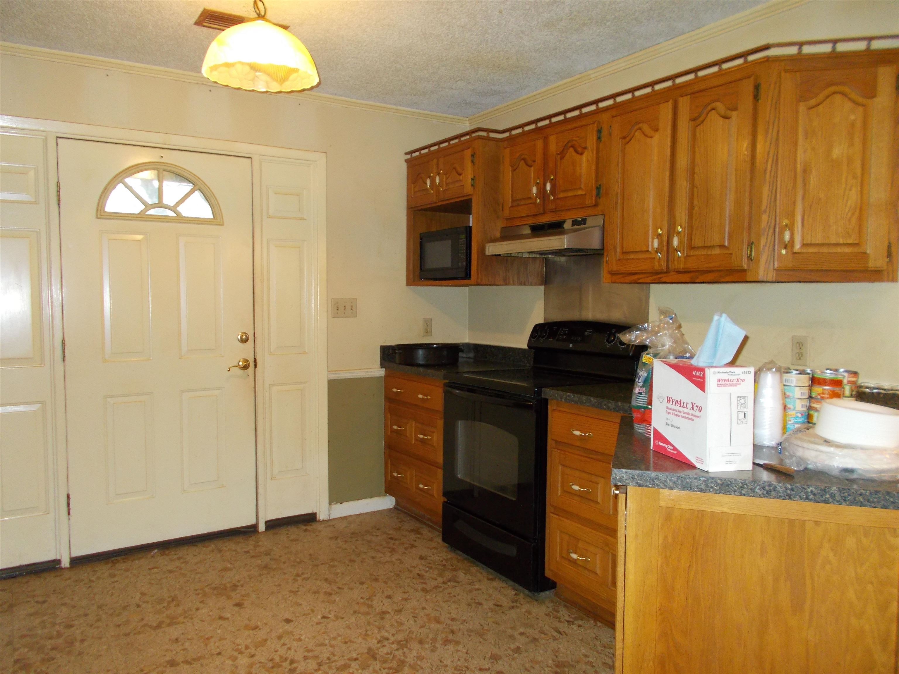 1058 Thumb Road Henning, TN 38041 - Photo 10 of 25 a kitchen with stainless steel appliances granite countertop a refrigerator and a stove top oven