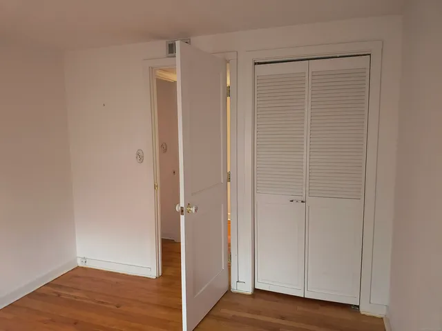 a view of a bathroom with wooden floor
