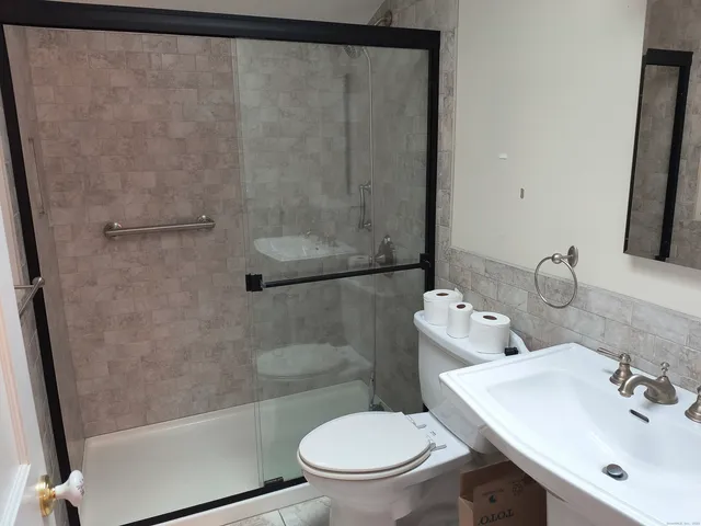 a bathroom with a sink toilet and shower