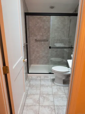 a bathroom with a toilet and a shower