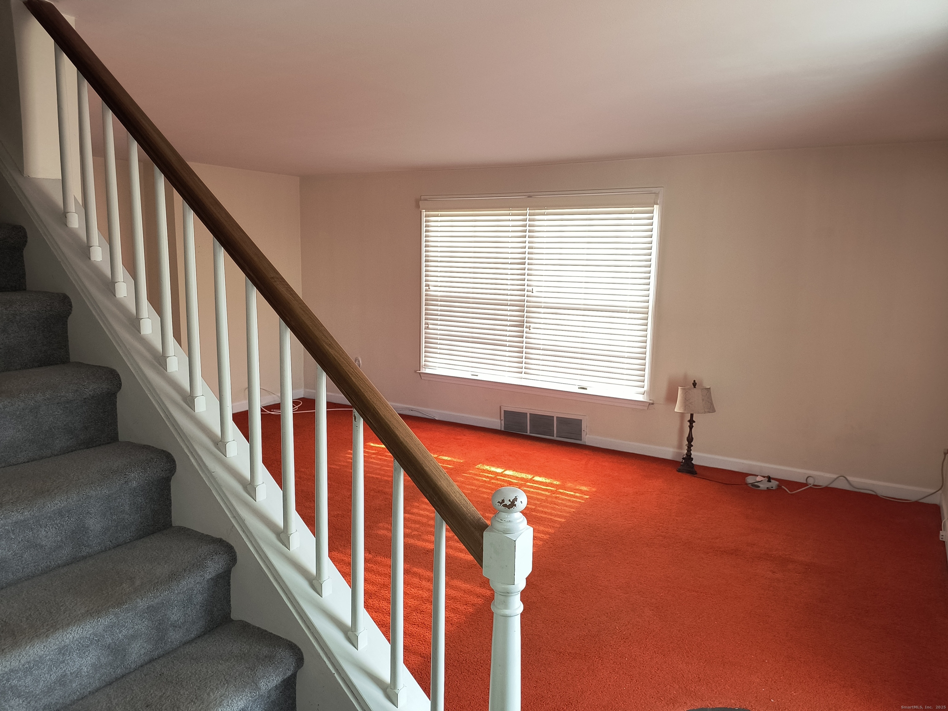 28 McLaughlin Terrace Derby, CT 06418 - Photo 26 of 37 a view of an empty room with wooden floor and stairs