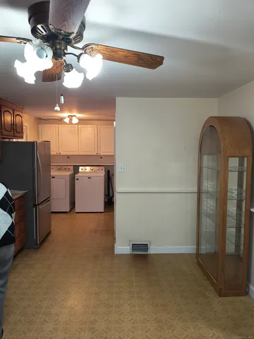 a view of a room with a kitchen