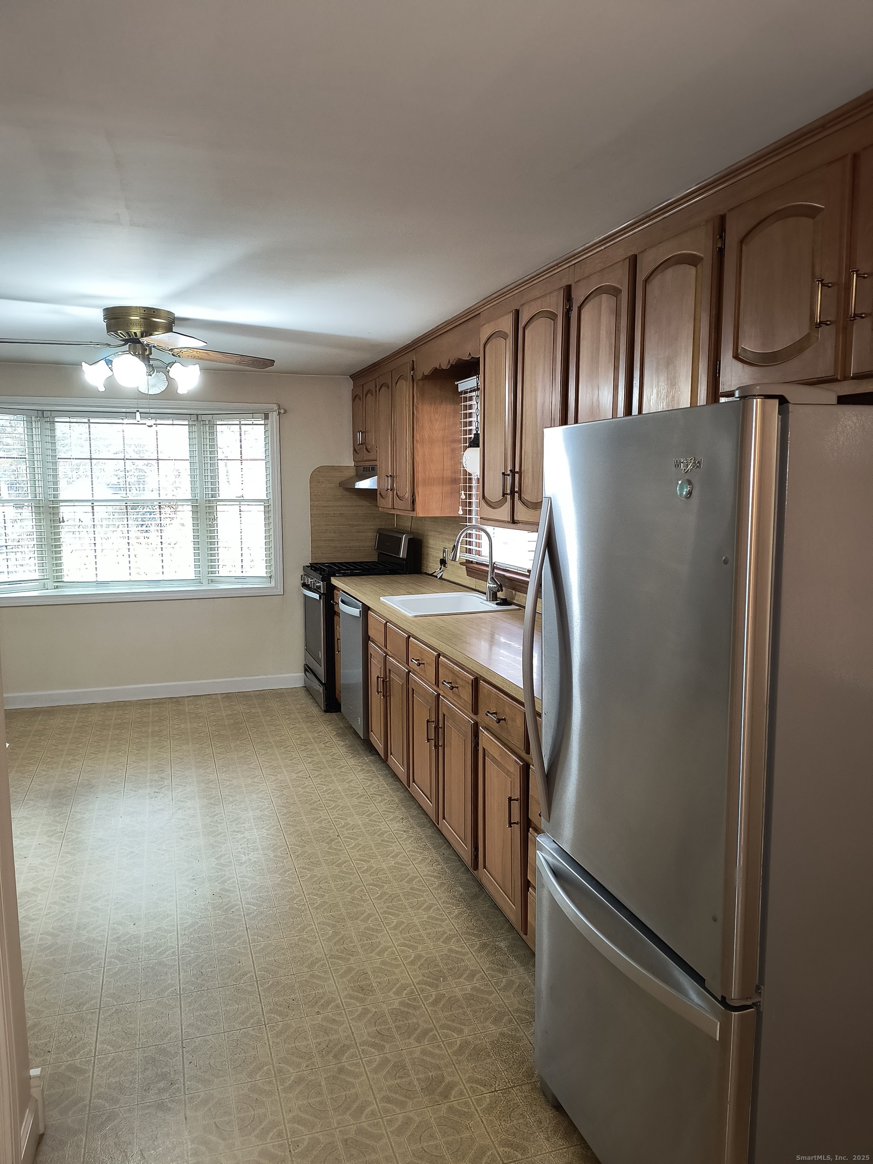 28 McLaughlin Terrace Derby, CT 06418 - Photo 34 of 37 a kitchen with stainless steel appliances granite countertop a refrigerator a stove a sink dishwasher and a refrigerator with wooden floor