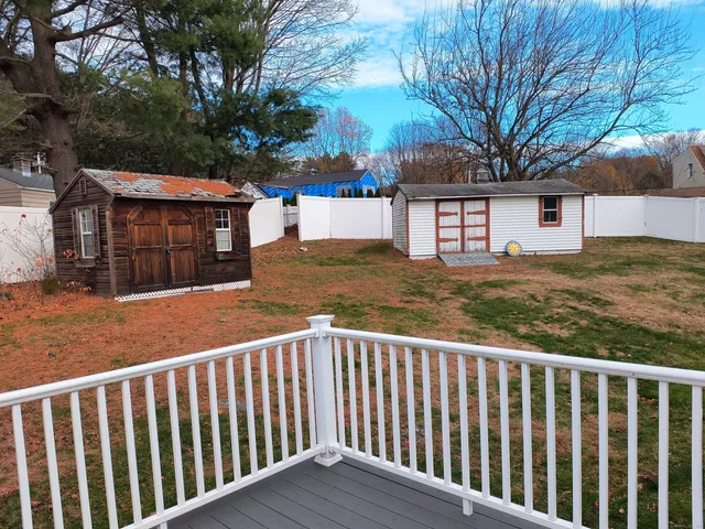 a view of a wooden fence and a yard