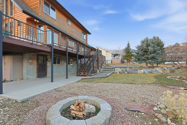 605 North Loafer Canyon Road Elk Ridge, UT 84651 - Photo 45 of 53 View of yard featuring a fire pit, a patio area, deck and ADU walkout