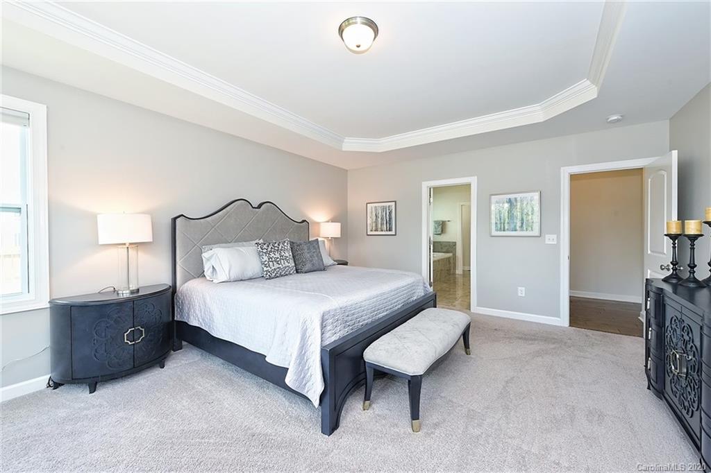 5321 Meadowcroft Way Fort Mill, SC 29708 - Photo 17 of 36 a bedroom with a bed and a lamp on dresser