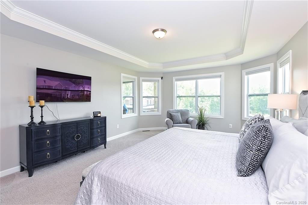 5321 Meadowcroft Way Fort Mill, SC 29708 - Photo 18 of 36 a spacious bedroom with a bed and a dresser