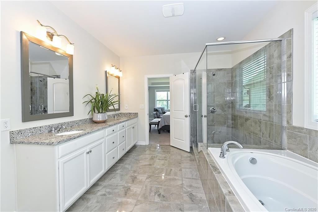 5321 Meadowcroft Way Fort Mill, SC 29708 - Photo 19 of 36 a bathroom with a granite countertop tub sink shower and mirror