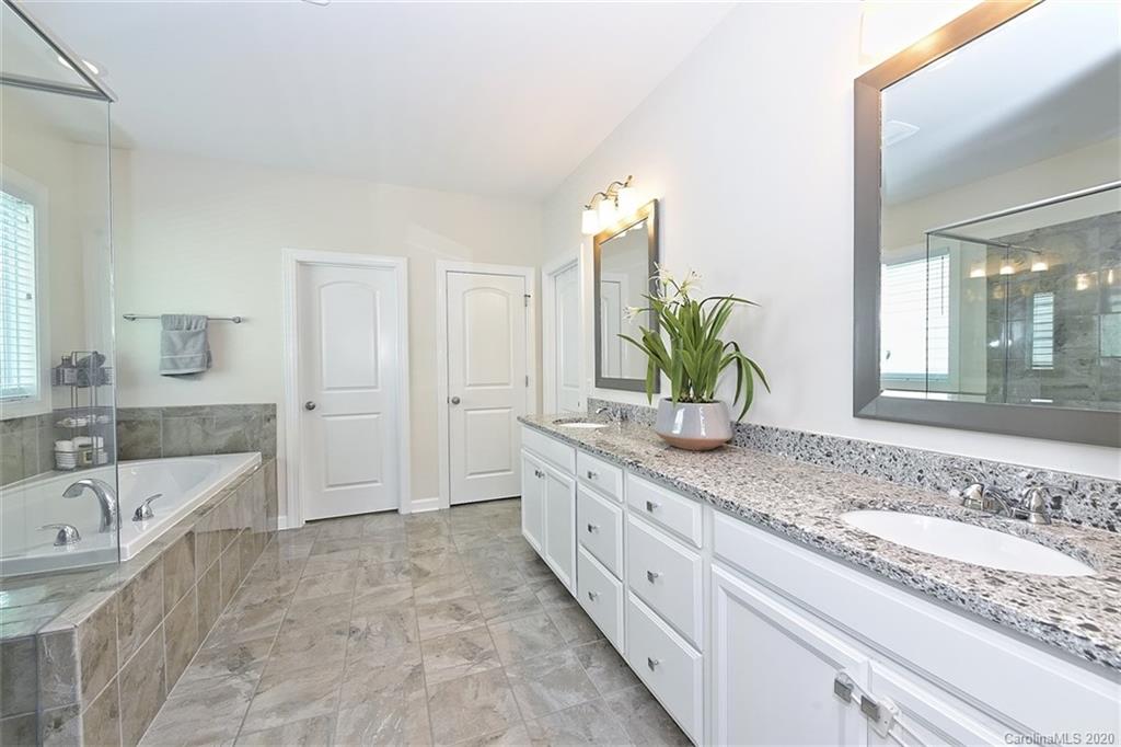 5321 Meadowcroft Way Fort Mill, SC 29708 - Photo 20 of 36 a bathroom with a granite countertop sink and a bathtub