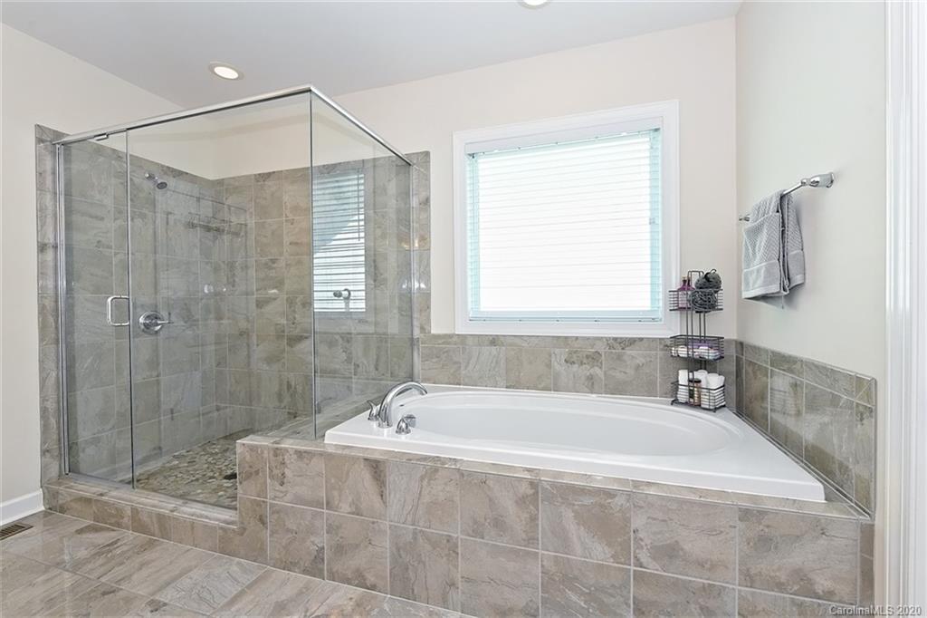 5321 Meadowcroft Way Fort Mill, SC 29708 - Photo 21 of 36 a spacious bathroom with a bathtub and shower