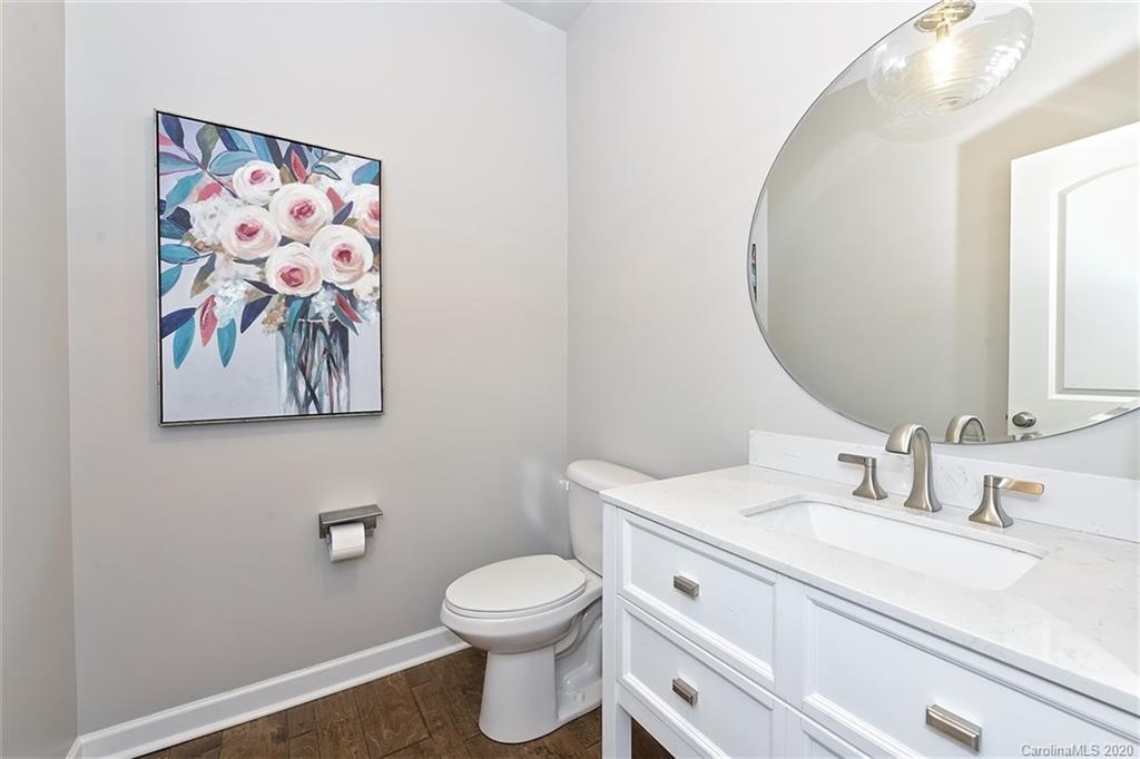 5321 Meadowcroft Way Fort Mill, SC 29708 - Photo 31 of 36 a bathroom with a toilet a sink and mirror