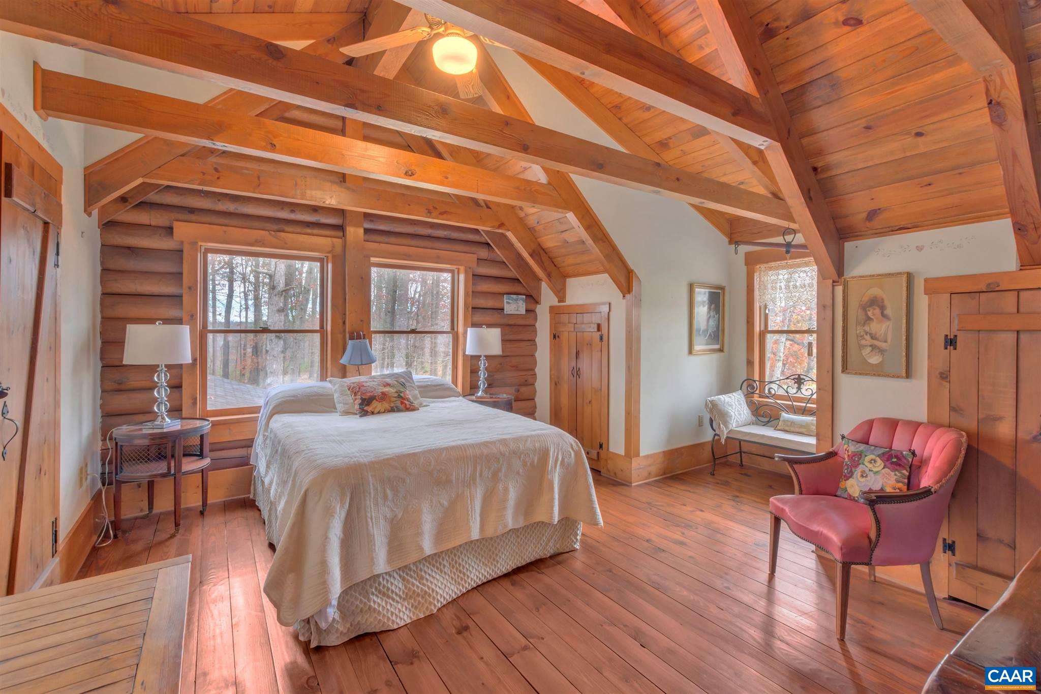 1054 Durrett Ridge Road Earlysville, VA 22936 - Photo 27 of 44 a bedroom with a bed and wooden floor