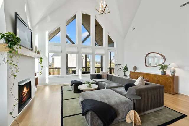 a living room with furniture a fireplace and a large window