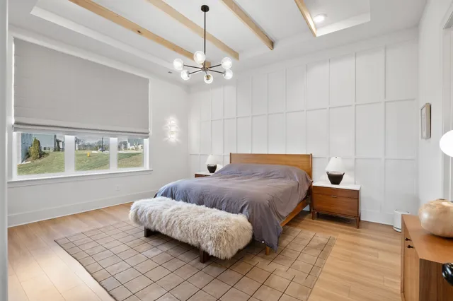 a bedroom with a large bed and a window