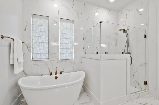 a white bath tub sitting next to a white sink