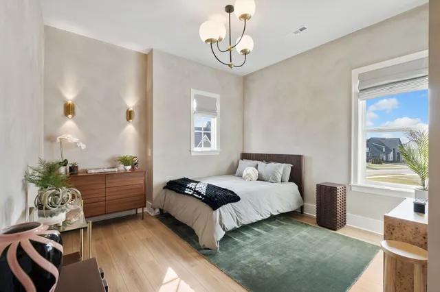 a bedroom with a bed and ceiling fan