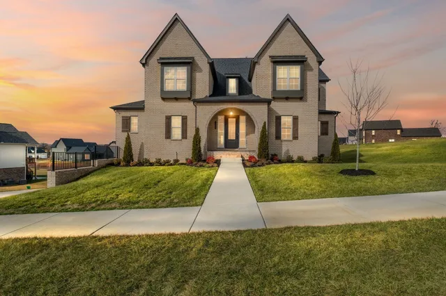 a front view of a house with a yard