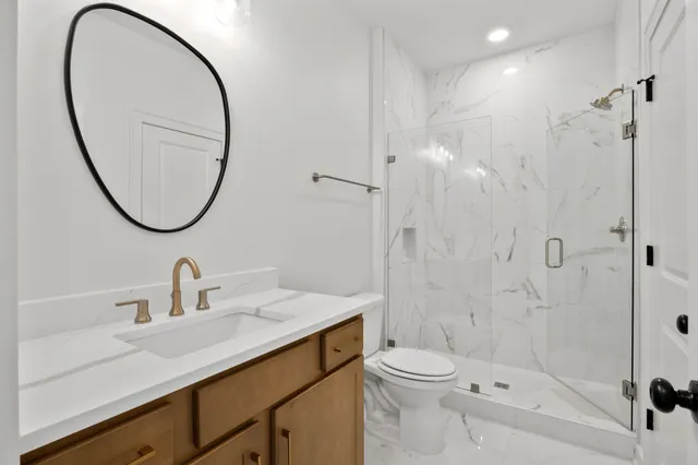 a bathroom with a sink a toilet and a mirror