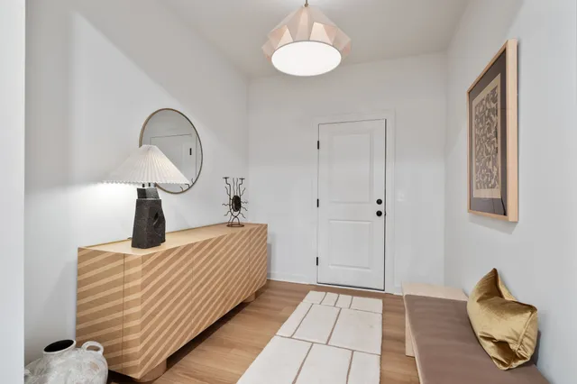 a bedroom with bed and wooden floor