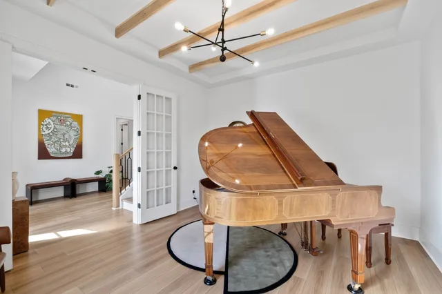 a living room with furniture a table and wooden floor