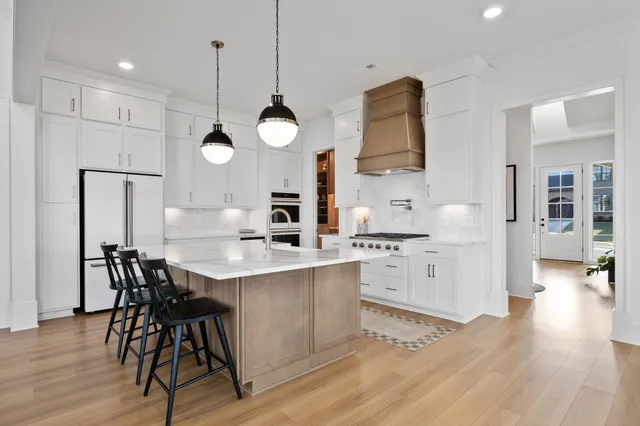 a kitchen with a table chairs sink and cabinets
