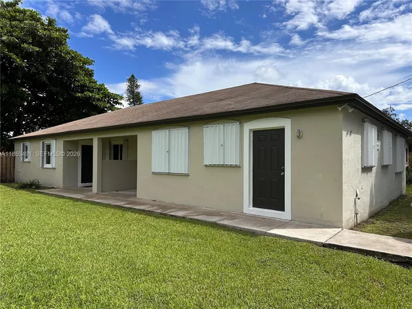 a house that has a big yard with wooden fence