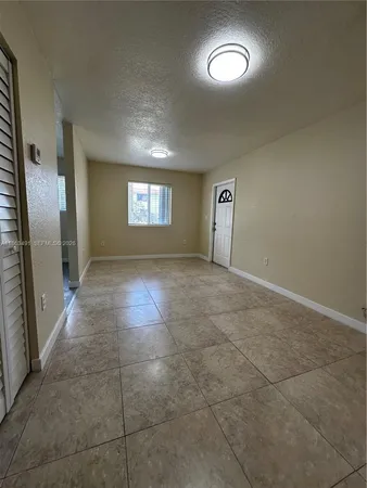 a view of an empty room and window