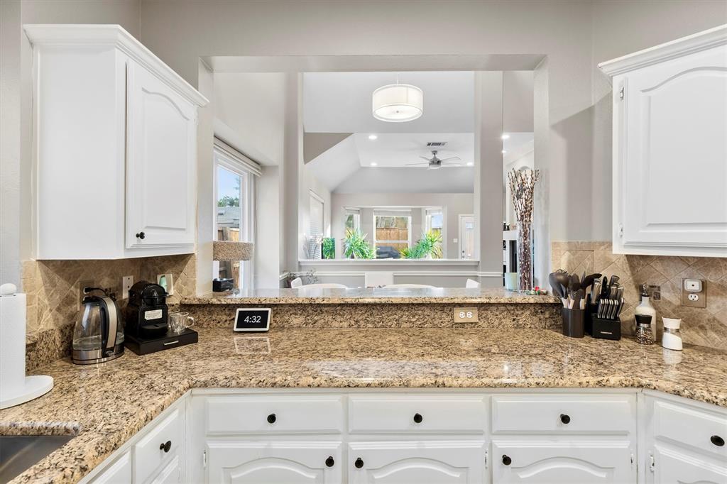 4008 Sherry Lane Addison, TX 75001 - Photo 11 of 39 a kitchen with granite countertop a sink a stove and cabinets
