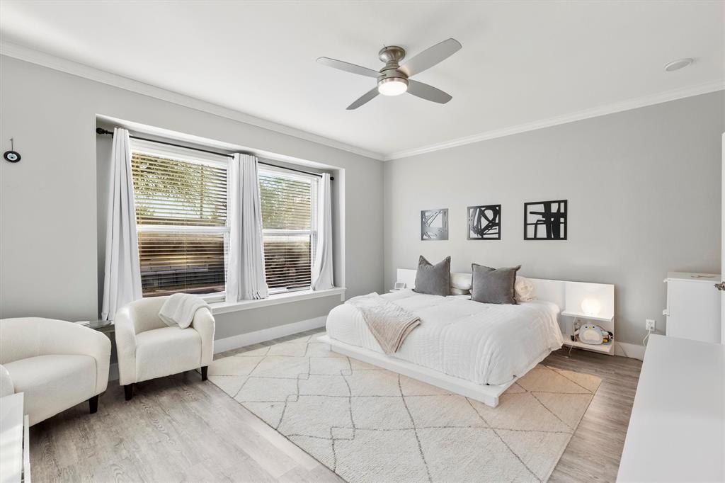 4008 Sherry Lane Addison, TX 75001 - Photo 14 of 39 a bedroom with a large bed couch and a window