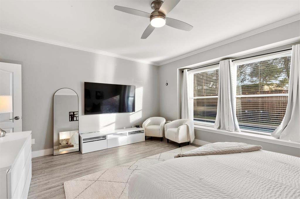 4008 Sherry Lane Addison, TX 75001 - Photo 16 of 39 a bedroom with a bed and large windows