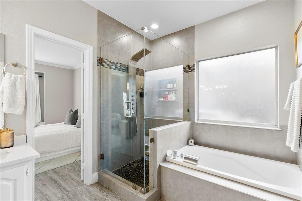 4008 Sherry Lane Addison, TX 75001 - Photo 18 of 39 a bathroom with a bathtub and a shower