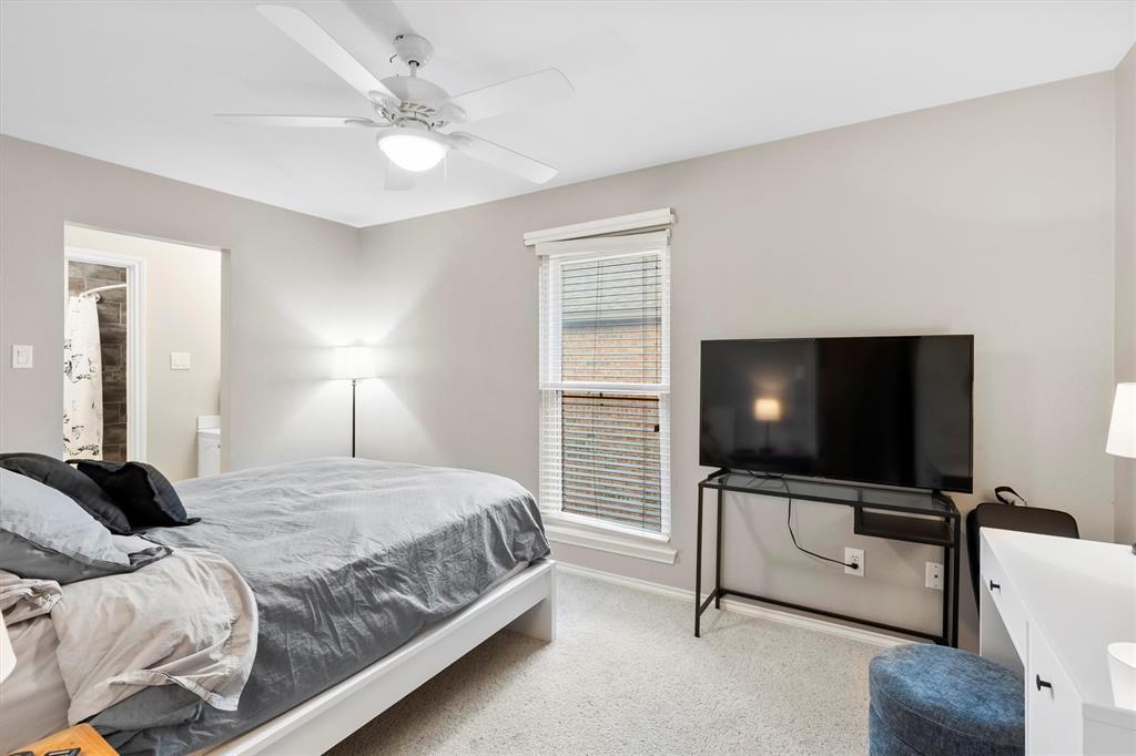 4008 Sherry Lane Addison, TX 75001 - Photo 19 of 39 a bedroom with a bed and a flat screen tv on the dresser