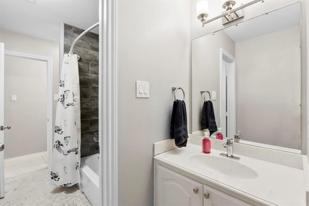 4008 Sherry Lane Addison, TX 75001 - Photo 21 of 39 a bathroom with a sink vanity and a mirror