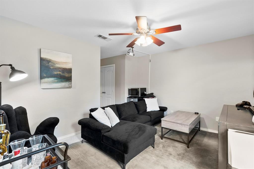 4008 Sherry Lane Addison, TX 75001 - Photo 23 of 39 a living room with furniture a ceiling fan and a rug