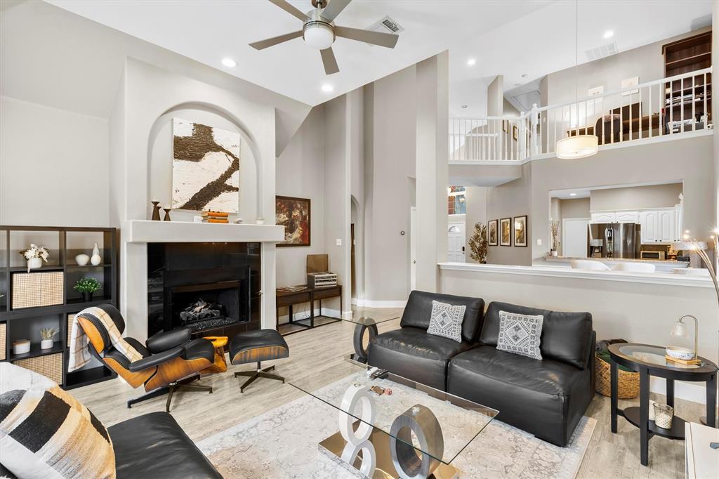4008 Sherry Lane Addison, TX 75001 - Photo 3 of 39 a living room with furniture a fireplace and a flat screen tv