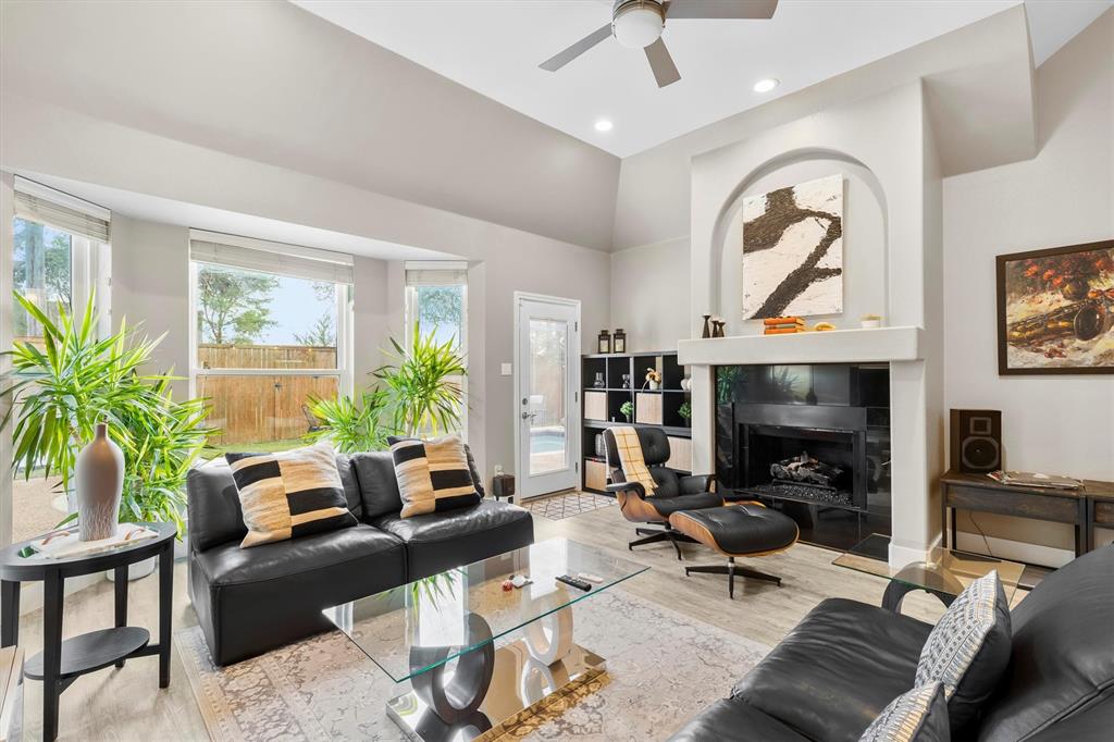 4008 Sherry Lane Addison, TX 75001 - Photo 5 of 39 a living room with furniture a large window and a fireplace