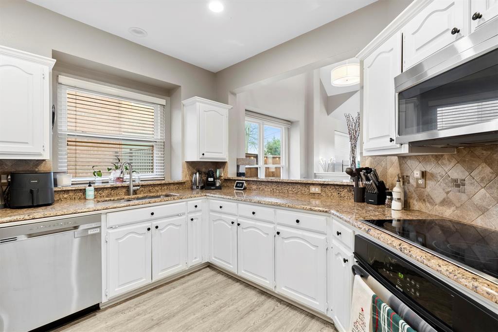 4008 Sherry Lane Addison, TX 75001 - Photo 9 of 39 a kitchen with sink cabinets and appliances