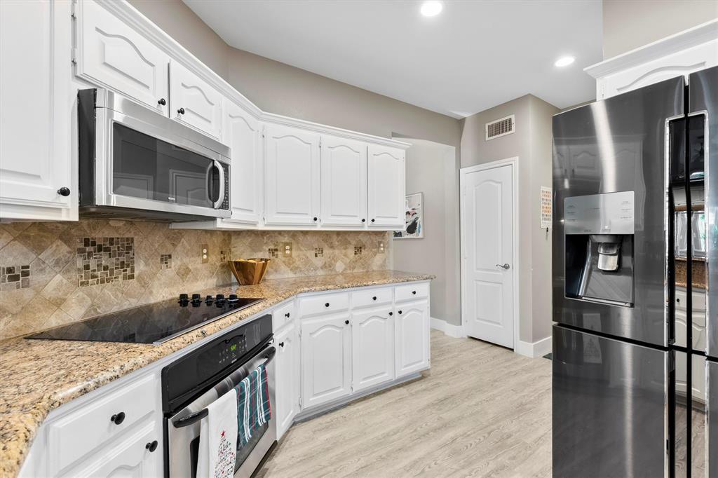 4008 Sherry Lane Addison, TX 75001 - Photo 10 of 39 a kitchen with stainless steel appliances granite countertop a refrigerator sink and cabinets
