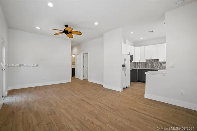 a view of a kitchen with wooden floor and a sink