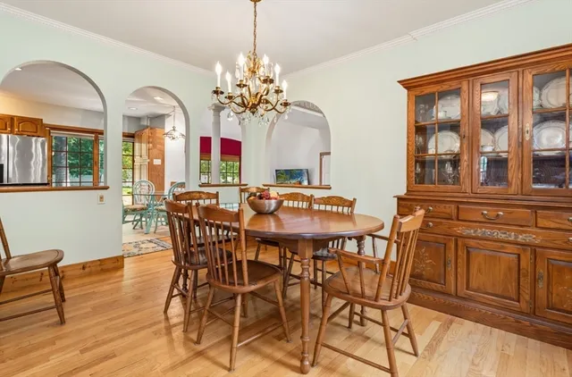 a living room with furniture flat screen tv and windows