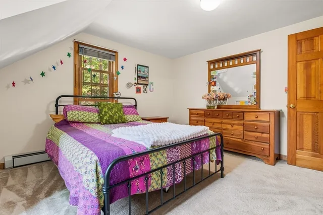 a bedroom with furniture and a flat screen tv